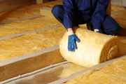 Insulation being inserted in ceiling