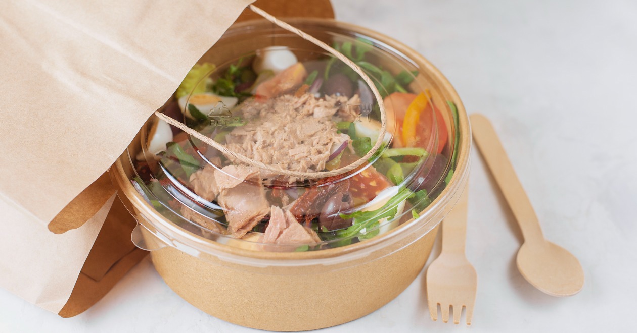 Take away salad in brown bowl and bag