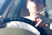 Person driving with a cigarette in hand