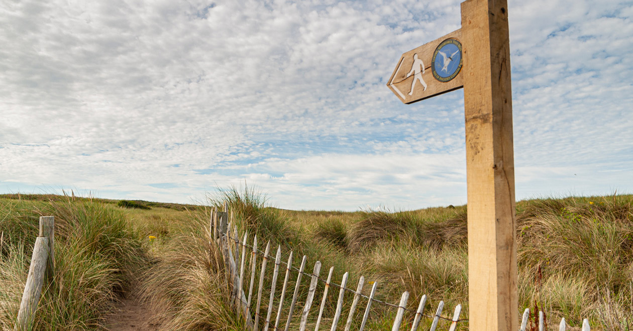 Welsh coast footpath with sign.