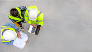 Arial view of three people wearing PPE huddled together 