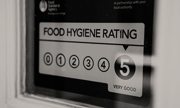 A food hygiene rating sticker displayed in a window