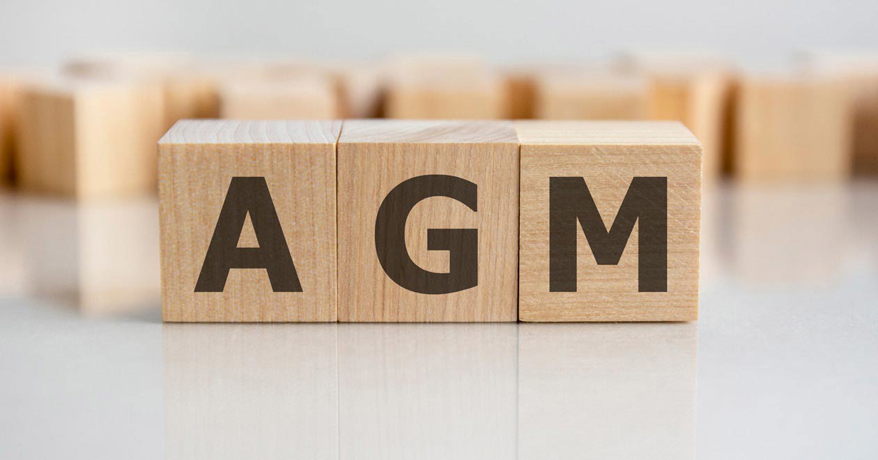 Wooden alphabet blocks arranged to spell AGM