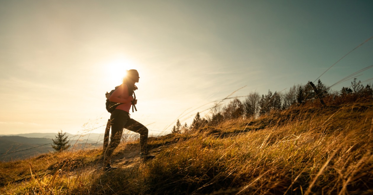 A woman hiking up a hill