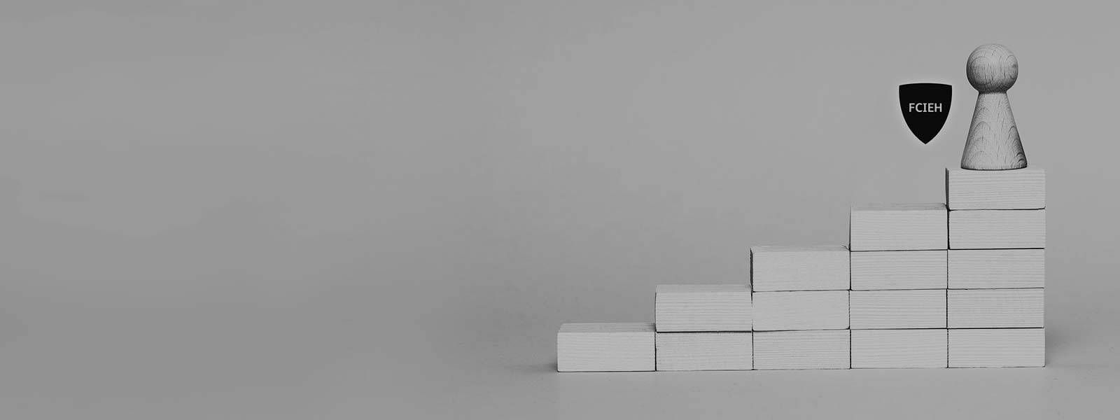 Affiliate badge with a wooden pawn on the first step of a tower of blocks