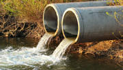 Two pipes discharging sewage into river