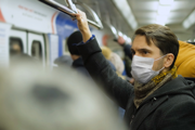 Man on train with mask on