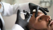 Man having botox injected into his forehead