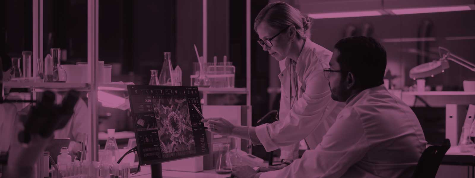 Two scientists looking at a computer screen