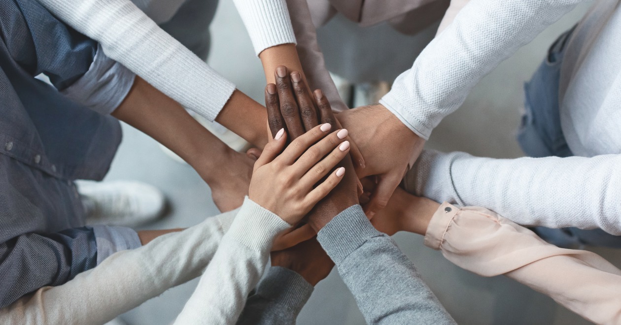 Group of people join hands