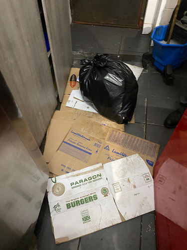 Photo of cardboard and rubbish on the floor