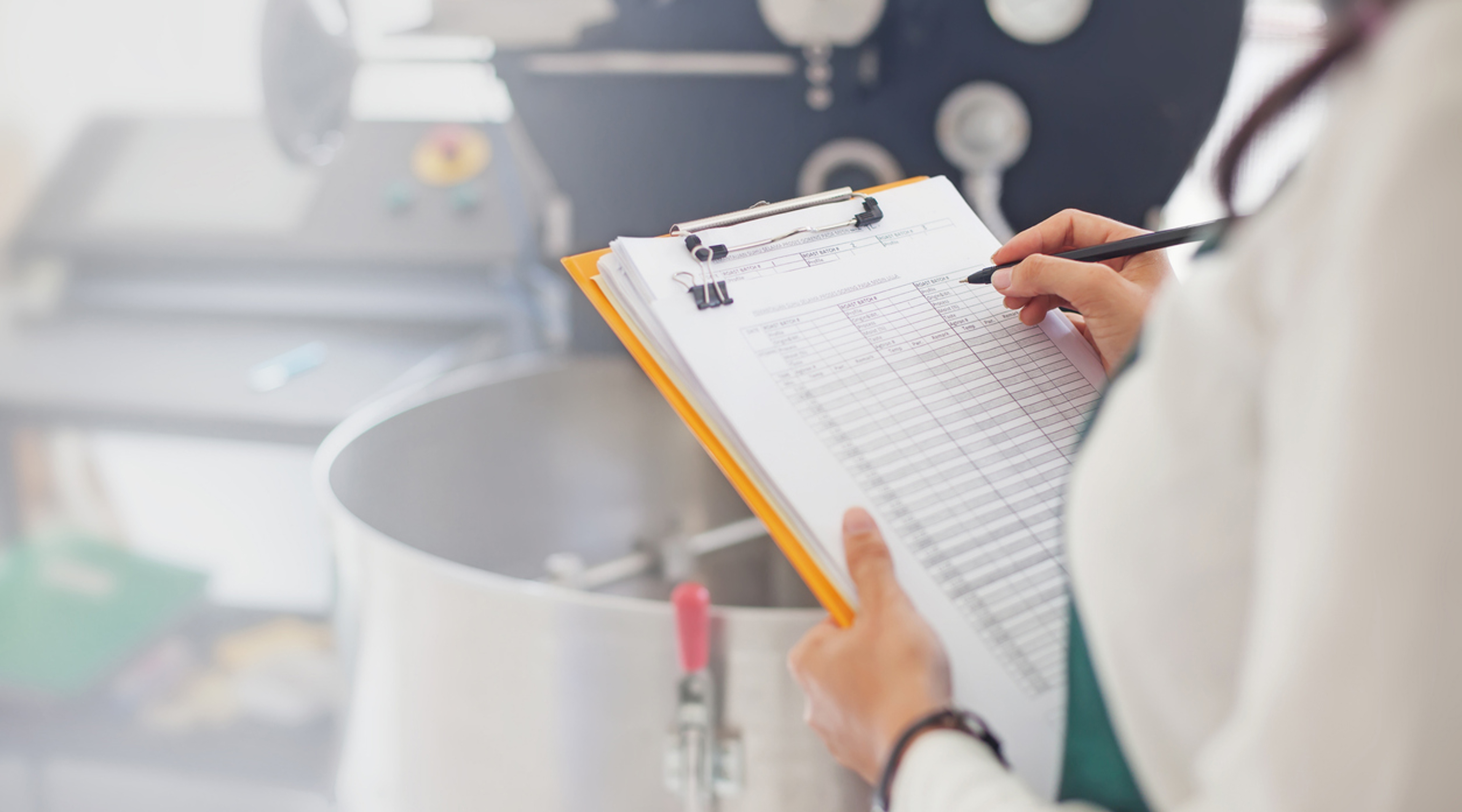 Person with a clipboard in a kitchen