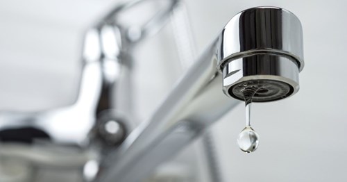 Image of a kitchen tap with water dripping from it