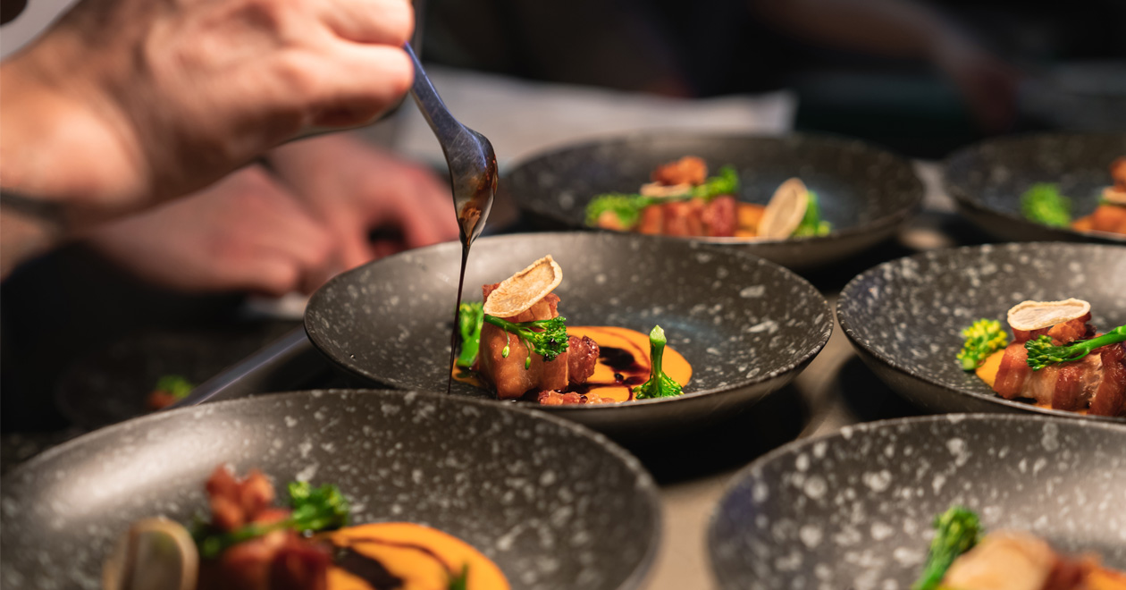 Chefs preparing food in professional kitchen