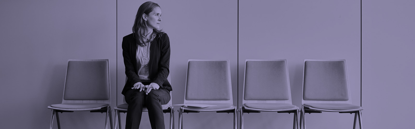Row of chairs with one person sitting